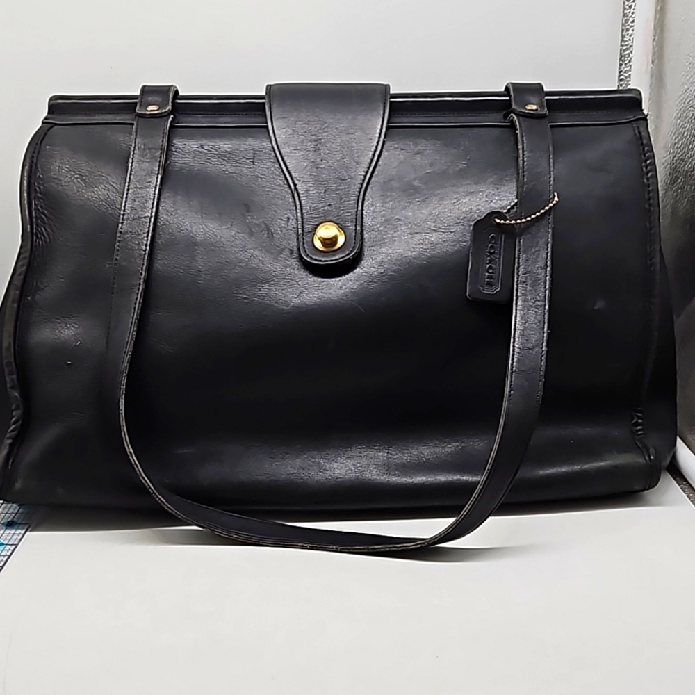 Black leather vintage, briefcase or tote. Old but in good shape. Fastener works